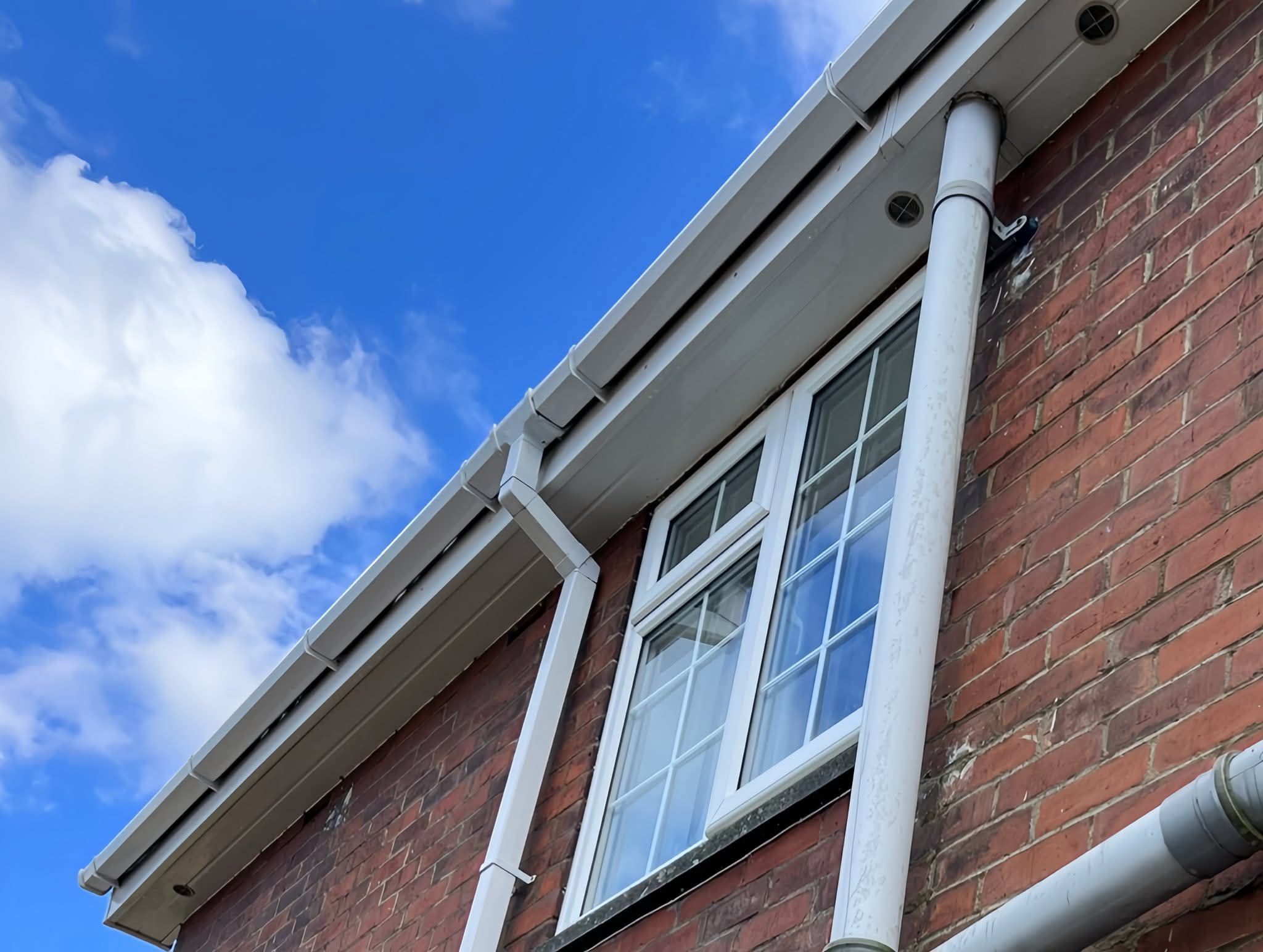 Gutter and downpipe at a residential roofline